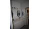Bathroom featuring double sink, white vanity, modern lighting, and shiplap accent wall at 146 Via Madrid Dr, Ormond Beach, FL 32176