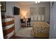 Cozy bedroom with a decorative dresser, window shutters, and a small breakfast nook at 146 Via Madrid Dr, Ormond Beach, FL 32176