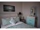 Comfortable bedroom with coastal decor features a white-washed bed frame and light green quilt at 146 Via Madrid Dr, Ormond Beach, FL 32176