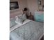 Bedroom featuring a whitewashed bed frame, coastal decor, and a relaxing atmosphere at 146 Via Madrid Dr, Ormond Beach, FL 32176