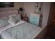 Bedroom with a cozy bed, artwork, and a charming turquoise dresser at 146 Via Madrid Dr, Ormond Beach, FL 32176