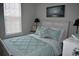 Bedroom featuring a cozy bed, natural light, and bedside tables with lamps at 146 Via Madrid Dr, Ormond Beach, FL 32176