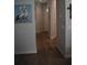 Hallway with wood flooring, neutral walls, and pelican artwork at 146 Via Madrid Dr, Ormond Beach, FL 32176
