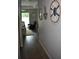 Bright hallway with wood flooring and nautical themed decorations leading to the outdoor patio at 146 Via Madrid Dr, Ormond Beach, FL 32176