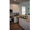 Modern kitchen featuring stainless steel appliances, granite countertops, and white cabinetry at 146 Via Madrid Dr, Ormond Beach, FL 32176