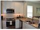 Beautiful kitchen featuring stainless steel appliances, granite countertops, and ample natural light at 146 Via Madrid Dr, Ormond Beach, FL 32176