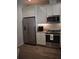 Well-equipped kitchen with stainless steel refrigerator, range, and granite countertops at 146 Via Madrid Dr, Ormond Beach, FL 32176