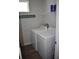 Laundry room featuring modern appliances, shelving, and a 'Beach House' sign at 146 Via Madrid Dr, Ormond Beach, FL 32176