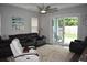 Bright living room with sliding glass doors leading to the backyard and patio at 146 Via Madrid Dr, Ormond Beach, FL 32176