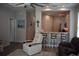 Stylish living room with breakfast bar, white chairs, and hardwood flooring at 146 Via Madrid Dr, Ormond Beach, FL 32176