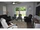 Cozy living room with backyard views from sliding glass doors at 146 Via Madrid Dr, Ormond Beach, FL 32176