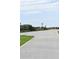 Asphalt road with sandy beach access and dune vegetation, close to the ocean at 146 Via Madrid Dr, Ormond Beach, FL 32176