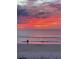 Scenic sunset at the beach with a Personal fishing and a heron standing in the ocean at 146 Via Madrid Dr, Ormond Beach, FL 32176