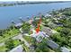 Aerial view showcasing the gray roof and landscaped yard of the single-story home near the water at 1650 Riverside Dr, Daytona Beach, FL 32117