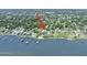 An aerial view capturing a waterfront home with a private dock and serene water access at 1650 Riverside Dr, Daytona Beach, FL 32117