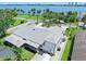 Aerial view showcasing the gray roof and landscaped yard of the single-story home near the water at 1650 Riverside Dr, Daytona Beach, FL 32117