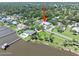 Aerial view of charming single-story home with a gray roof, circular driveway, and landscaped front yard in a neighborhood at 1650 Riverside Dr, Daytona Beach, FL 32117