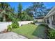 A backyard with a green lawn, small plants, and a white fence is perfect for outdoor activities and enjoying nature at 1650 Riverside Dr, Daytona Beach, FL 32117
