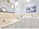 Bathroom showing a walk-in tub with fixtures, and a vanity with sink at 1650 Riverside Dr, Daytona Beach, FL 32117