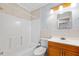 Bathroom features wood vanity, tub-shower combo, neutral tile, and white toilet at 1650 Riverside Dr, Daytona Beach, FL 32117