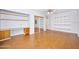 Bedroom with wood floors, built-in desk, mirrored closets, shelves and fan with lights at 1650 Riverside Dr, Daytona Beach, FL 32117