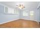 Bedroom featuring wood herringbone floors, ceiling fan, wall cabinets, and mirrored closet doors at 1650 Riverside Dr, Daytona Beach, FL 32117