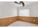 Bedroom showcasing wainscoting, a ceiling fan, a window, and tile flooring at 1650 Riverside Dr, Daytona Beach, FL 32117