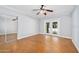 Bright bedroom features herringbone floors, ceiling fan, closet with mirrored doors, and French doors at 1650 Riverside Dr, Daytona Beach, FL 32117