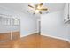 Bedroom featuring wood herringbone floors, ceiling fan, and mirrored closet doors at 1650 Riverside Dr, Daytona Beach, FL 32117