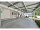 A covered patio features neutral paint, concrete flooring, and ample space for seating and outdoor activities at 1650 Riverside Dr, Daytona Beach, FL 32117