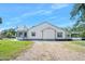 An exterior shot shows a home with a well-maintained yard, a turret, and gravel in the side yard at 1650 Riverside Dr, Daytona Beach, FL 32117