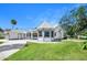An exterior shot of a well-maintained home with a manicured lawn, a charming turret, and a spacious driveway at 1650 Riverside Dr, Daytona Beach, FL 32117