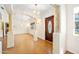 A bright foyer showcasing herringbone floors, decorative columns, and arched entryways at 1650 Riverside Dr, Daytona Beach, FL 32117
