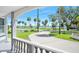 Inviting front porch with views of a serene waterfront property, framed by lush greenery at 1650 Riverside Dr, Daytona Beach, FL 32117