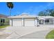 An inviting two-car garage with manicured landscaping offers both convenience and curb appeal at 1650 Riverside Dr, Daytona Beach, FL 32117