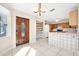 Well-lit kitchen adjacent to the front entry featuring tile floors, and stainless appliances at 1650 Riverside Dr, Daytona Beach, FL 32117
