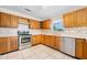Well-lit kitchen featuring wood cabinets, white countertops, and stainless steel appliances at 1650 Riverside Dr, Daytona Beach, FL 32117
