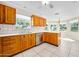 Traditional kitchen featuring wood cabinets, white countertops, and stainless steel appliances at 1650 Riverside Dr, Daytona Beach, FL 32117