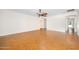 Open living room with hardwood floors and an open doorway leading to ensuite bathroom at 1650 Riverside Dr, Daytona Beach, FL 32117