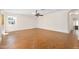 Open living room with a ceiling fan, hardwood floors, and natural light at 1650 Riverside Dr, Daytona Beach, FL 32117
