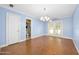 Living room with herringbone wood floors and a view into an ensuite bathroom at 1650 Riverside Dr, Daytona Beach, FL 32117
