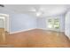 Open living room with herringbone-patterned wood floors and a ceiling fan at 1650 Riverside Dr, Daytona Beach, FL 32117