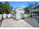 Exterior view of the shed with tanks, ladders, and lush greenery at 1650 Riverside Dr, Daytona Beach, FL 32117