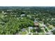 Aerial view of a home nestled in a lush, wooded community with a nearby lake at 24 Katrinas Dr, Ormond Beach, FL 32174