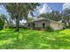 Lush backyard with plenty of green space and mature trees, perfect for relaxing and entertaining at 24 Katrinas Dr, Ormond Beach, FL 32174