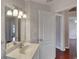 Bathroom with vanity, decorative lighting and white patterned wallpaper at 24 Katrinas Dr, Ormond Beach, FL 32174