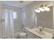 Well-lit bathroom with shower and tub combination and patterned wallpaper at 24 Katrinas Dr, Ormond Beach, FL 32174