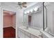Bathroom vanity featuring wide mirror, vanity, overhead lighting and view of bedroom at 24 Katrinas Dr, Ormond Beach, FL 32174