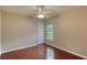 Bedroom with hardwood floors, ceiling fan and natural light from window at 24 Katrinas Dr, Ormond Beach, FL 32174