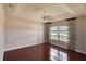 Bright bedroom features tray ceiling, ceiling fan, and window with wood flooring at 24 Katrinas Dr, Ormond Beach, FL 32174